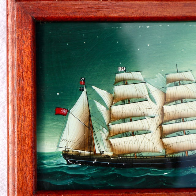 This product is a miniature clipper ship reverse painting on glass framed in a traditional folk art style. Handmade with...