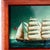 This product is a miniature clipper ship reverse painting on glass framed in a traditional folk art style. Handmade with...