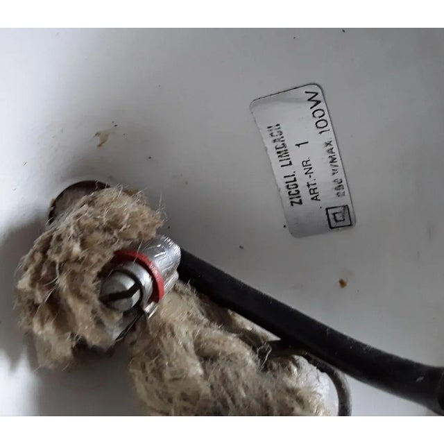 Rustic vintage ceiling lamp made of rough, dark brown outside unglazed, inside light glazed ceramic with a sisal wrapped...