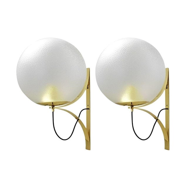 A striking set of four vintage Italian wall sconces, circa 1960's, featuring large spherical Murano glass globes mounted...