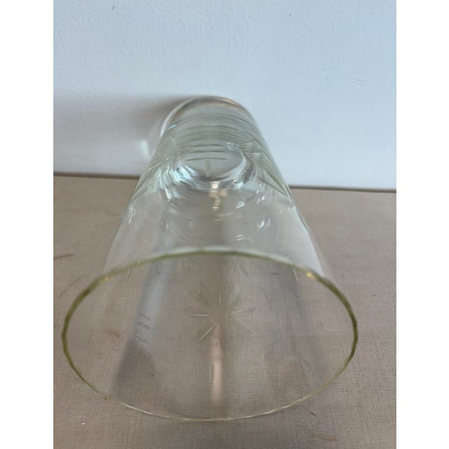 Beautiful etched glass floral vase with scalloped edges.