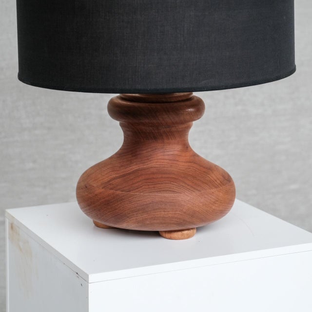 A chunky wooden table lamp. Italy, c1980s. Paired with original black shade. Good condition generally, some scuffs...