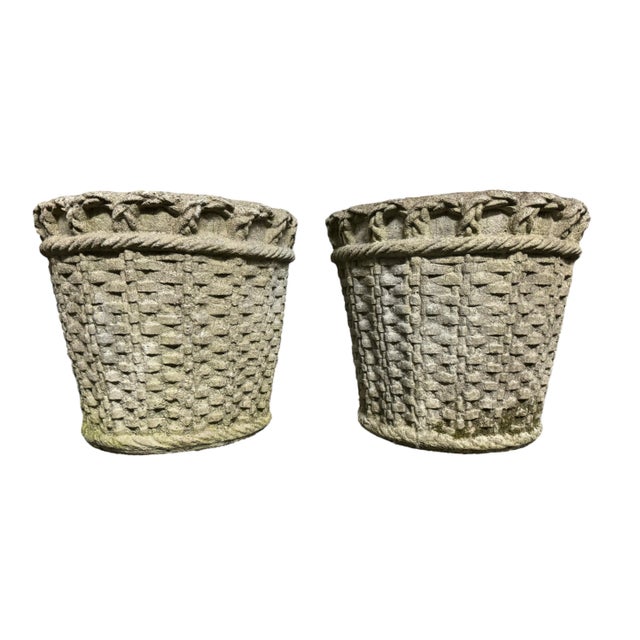 Large pair of cast stone woven planters. The sides resemble a basket with a woven handle detail on top. Great for a lemon...