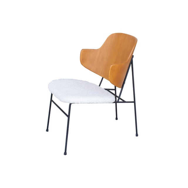 A Mid Century Modern Penguin lounge chair designed by Danish furniture designer Ib Kofod-Larsen (1921-2003). The iconic...