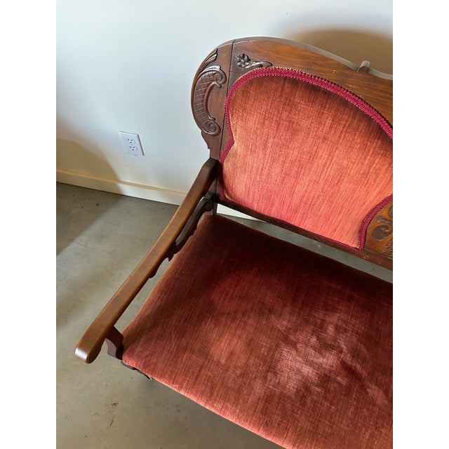 Antique Carved Oak bench with scroll detail and curved arms.