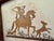 The paper backing behind the work includes fragments of a German-language printed page in Fraktur type, suggesting a...