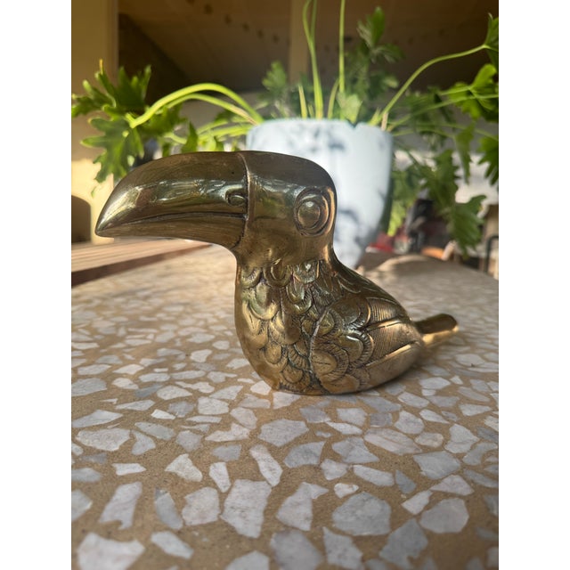 Large brass toucan figurine, often attributed to the artist Dolbi Cashier from the mid-20th century. Constructed from...