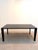 sleek and contemporary dining table featuring a premium black ceramic tabletop with elegant white marble-effect veining....