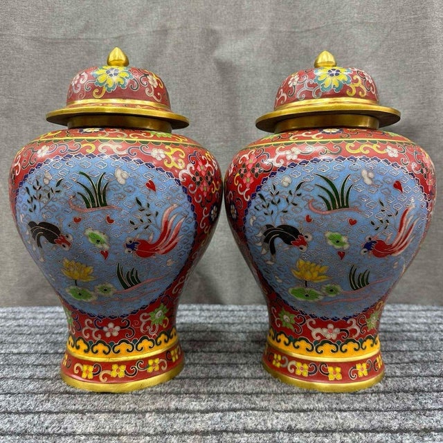 A beautiful pair of Chinese Cloisonné Enamel "General Jars." These vibrant vessels feature a central panel of colorful koi...