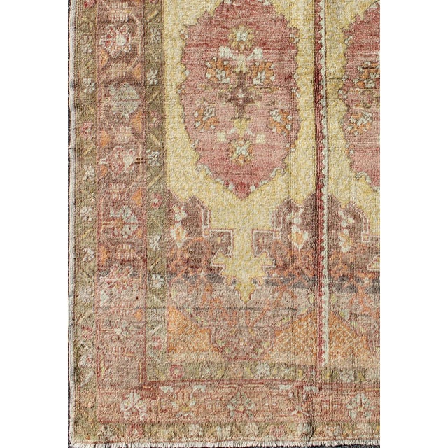 Unique midcentury Turkish Oushak rug with two medallion panels in yellow, brown, orange and soft red. Keivan Woven Arts /...