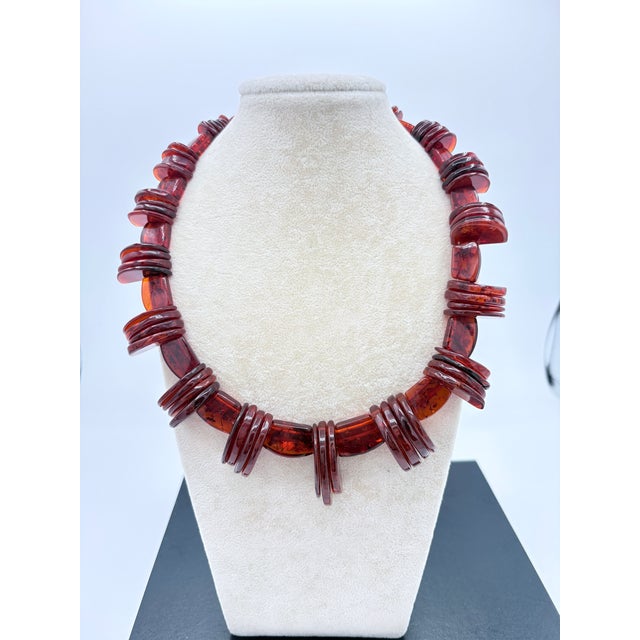A striking mid‑century Baltic amber necklace featuring hand‑cut cognac slabs, each showcasing natural inclusions and rich...