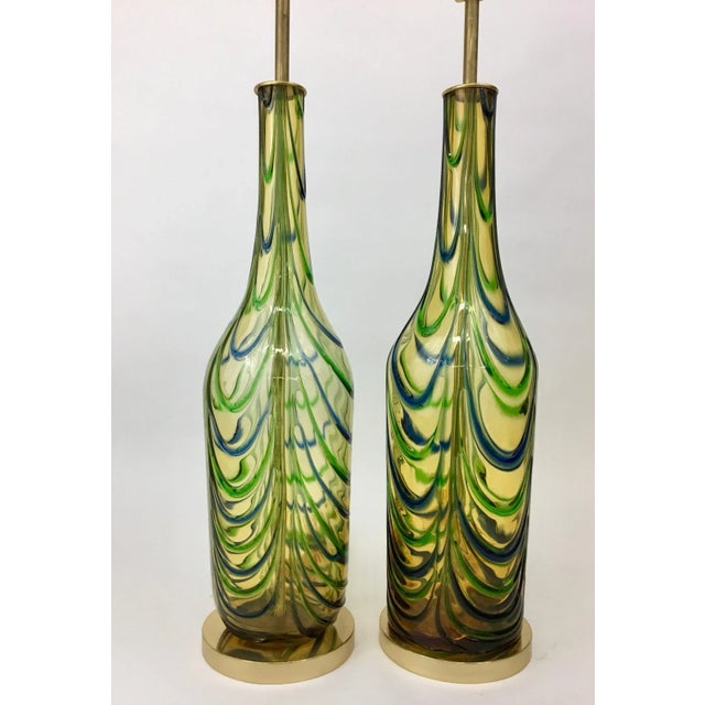 Striking pair of vintage Murano glass lamp bodies in a bottle form, fitted with all new high quality brass hardware and...