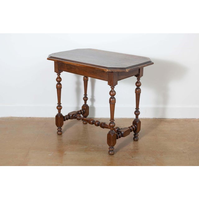 A charming 19th-century French side table crafted from solid wood, showcasing the craftsmanship and style of the period....