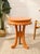 A playful vintage 1970s side table with a round top, decorative scalloped apron, and curving legs, finished in a soft...