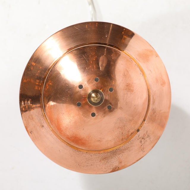 Executed in richly patinated, high-polish copper, this streamlined lamp exemplifies the Machine Age aesthetic of the...