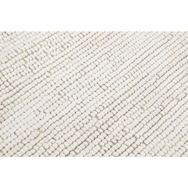 This beautiful Felt hand-woven wool rug is part of our Westport Collection with an Ivory color field and features an all-...