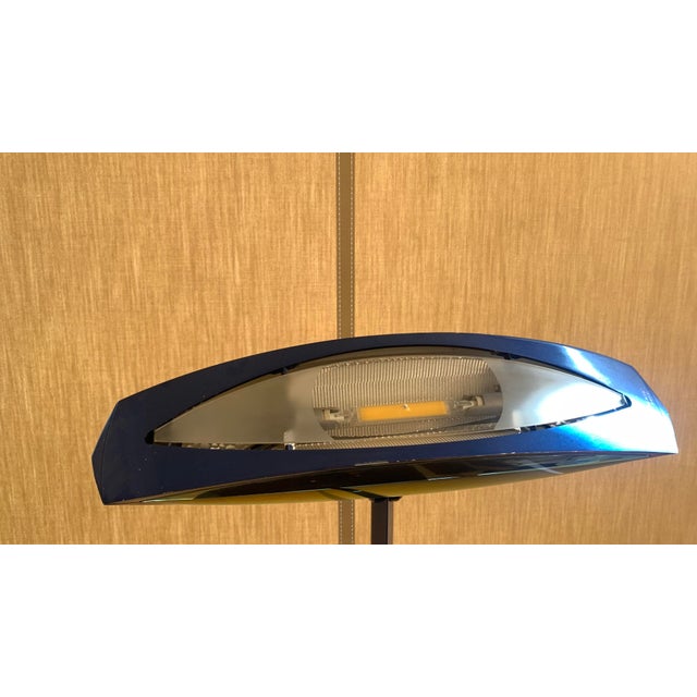 The object shown is a modern design floor lamp by Flos \. by Fabio Lombardo., characterized by a thin and slender...