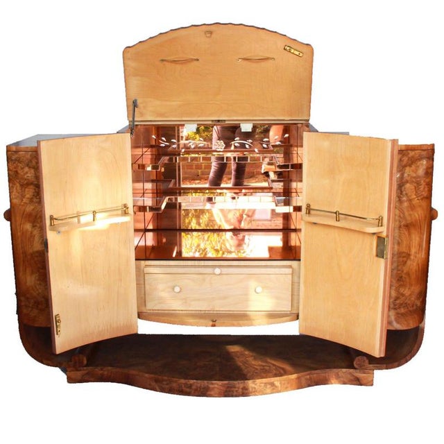 An Art Deco, serpentine u-shaped walnut cocktail sideboard attributed to Harry & Lou Epstein. Decoserpentine u-shaped...