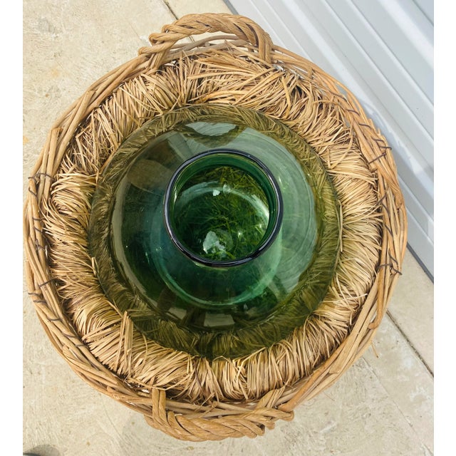 This is a hand blown French country green glass jar with a hand woven basket that surrounds it. This large green glass jug...