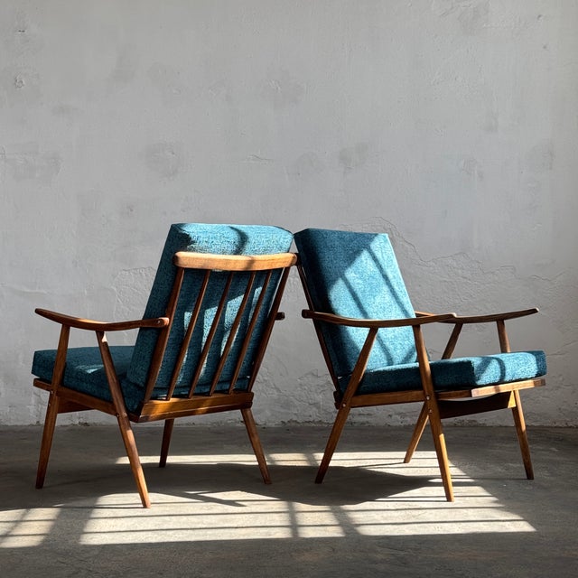 This pair of lounge chairs is a quintessential example of mid-century modern design from the 1960s, manufactured by the...