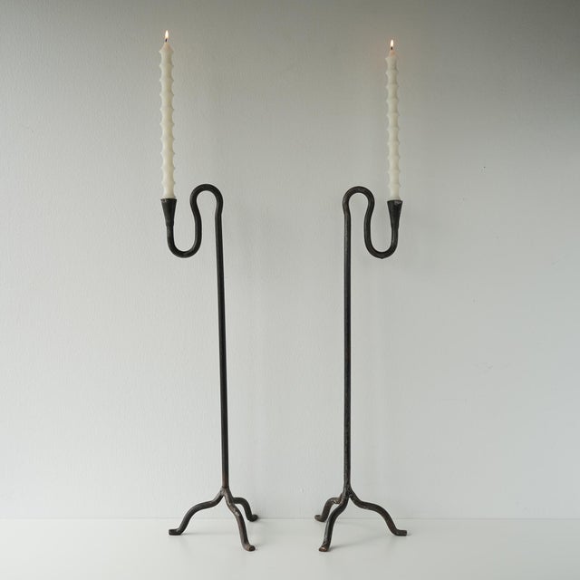 Vintage mid 20th century sculptural wrought iron candle holders. Hand forged in black wrought iron, this pair of candle...