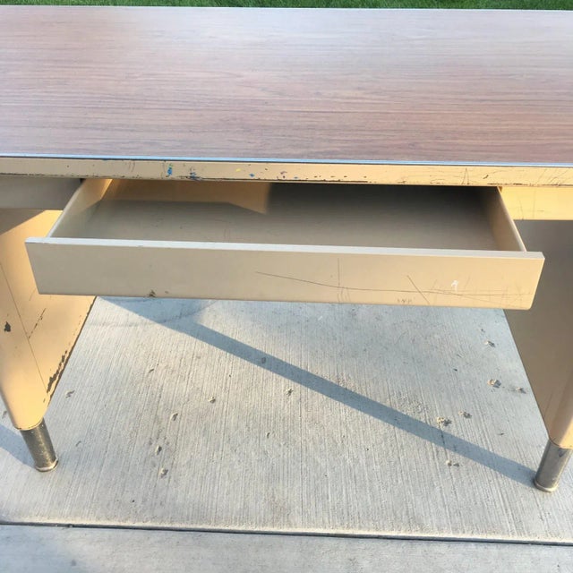 Machine-age industrial tanker desk with two panel legs, signature chrome pontoon self leveling feet, walnut veneer top,...