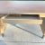 Machine-age industrial tanker desk with two panel legs, signature chrome pontoon self leveling feet, walnut veneer top,...