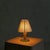 A petite Italian table lamp from the 1950s, standing just 9 inches tall. The ivory-lacquered metal stem rises from a...