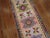 Charming late20th century hand-knotted Turkish Runner featuring a bubble gum pink field with glittered cotton accents...