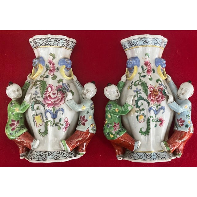 Fine pair 19th c. Chinese export porcelain wall pockets in a bright famille rose glaze. Each modeled as a vase with ho ho...