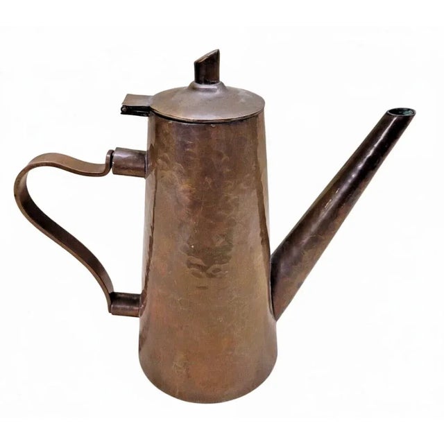 A beautifully handcrafted Arts & Crafts era copper coffee or tea pot, featuring a tapered conical form, long spout, and...
