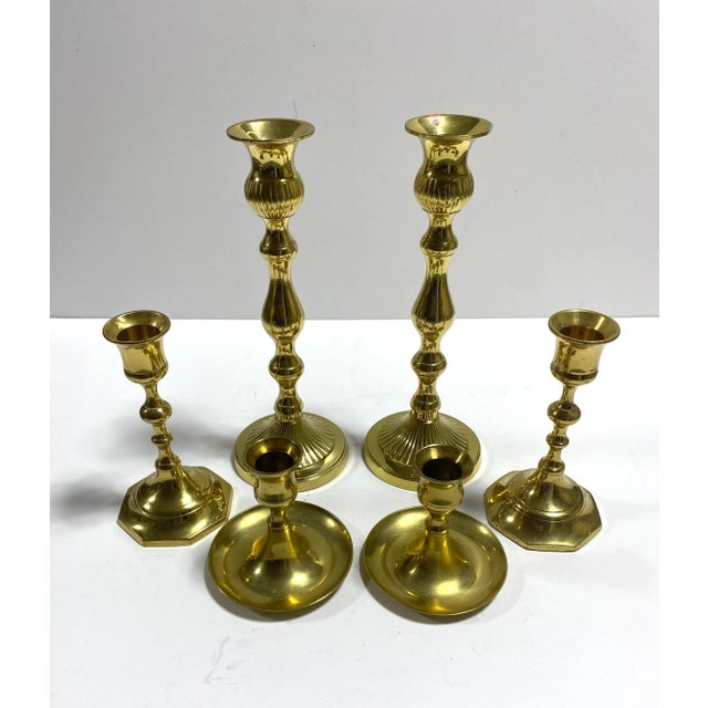 A versatile set of six vintage brass candlesticks in three graduated heights, with two of each size. Classic turned...