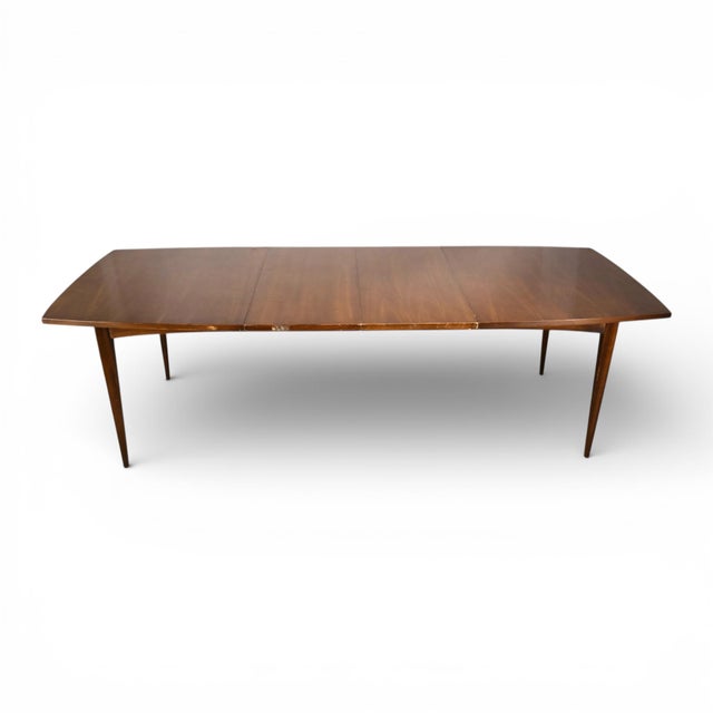 This vintage Broyhill Brasilia dining table dates to the 1960s and showcases the clean, architectural lines that define...