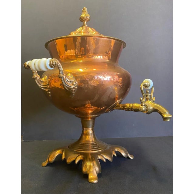 Mid 19th Century English Copper and Brass Samovar with porcelain handles. By Latham and cs hull. The base measures 7.5...