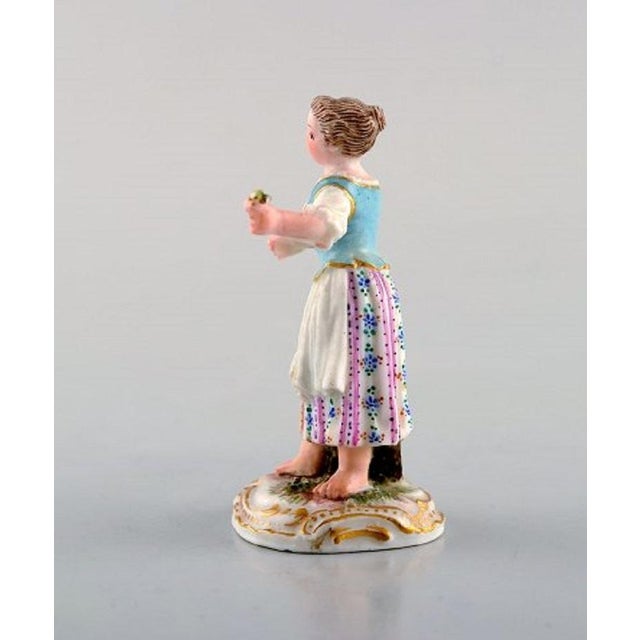 Rare antique Meissen miniature figure after Johann Joachim Kändler in hand painted porcelain. Girl with flowers. Dated...
