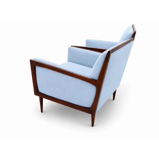 Modern mid-century style lounge chairs. The pair of chairs is newly upholstered and refinished. The chairs are done in a...