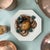 A charming Italian trompe l’oeil ceramic majolica plate featuring a richly modeled crab surrounded by mussels, olives, and...