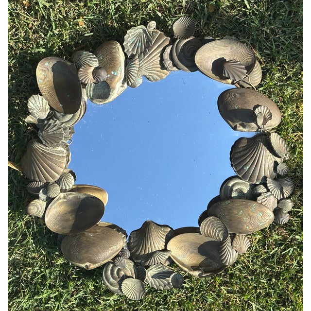 Sculptural vintage seashell round mirror with highly detailed layers of shells, scallops and clams in a beautifully aged...