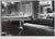 1982 black and white silver gelatin photograph of man in flat cap sitting in a diner. Signed illegibly, dated and titled...