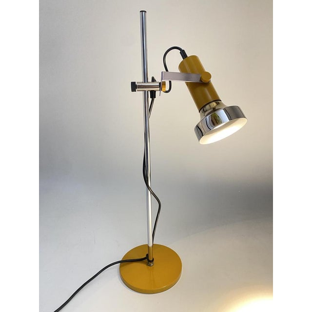 A table lamp * Manufacturer: SISCHE (Simon & Schelle) * Material: metal * Year: 1970s * Color: Silver, Chrome, Yellow *...