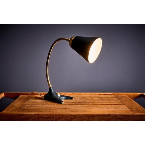 Ewå Värnamo Table Lamp in black metal and brass. The depth and width given applies to the base. The height is adjustable...
