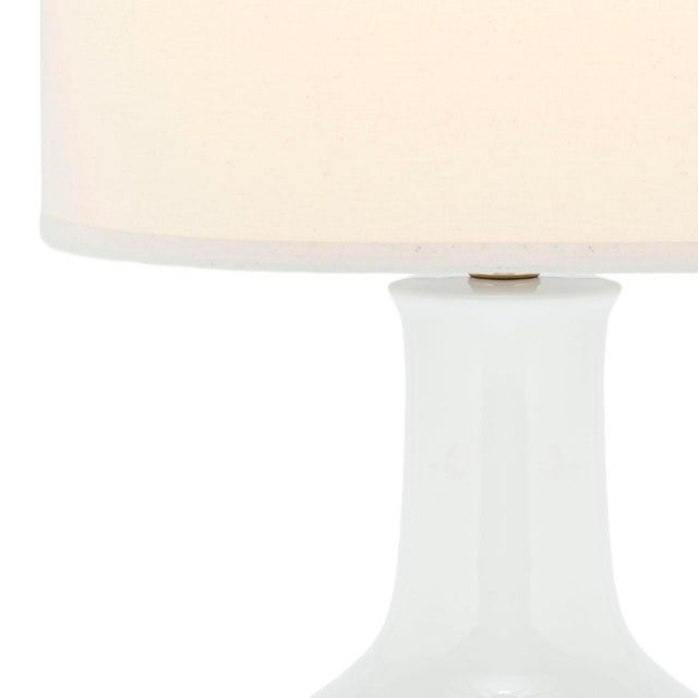 The Lamp is sure to illuminate any room with elegance and style. it's classic gourd body of pristine white glazed ceramic...