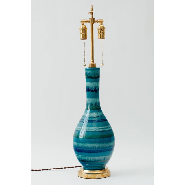 Italian ceramic lamp with stripe drip glaze in shades of turquoise, indigo, white and green. Solid brass base and hardware...
