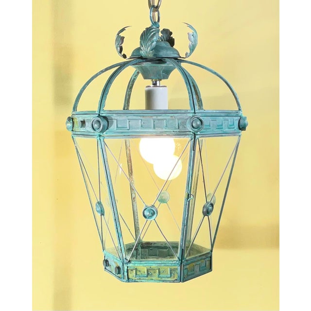 Elevate your space with this elegant, restored solid brass hanging lantern chandelier. Featuring a striking, verdigris...