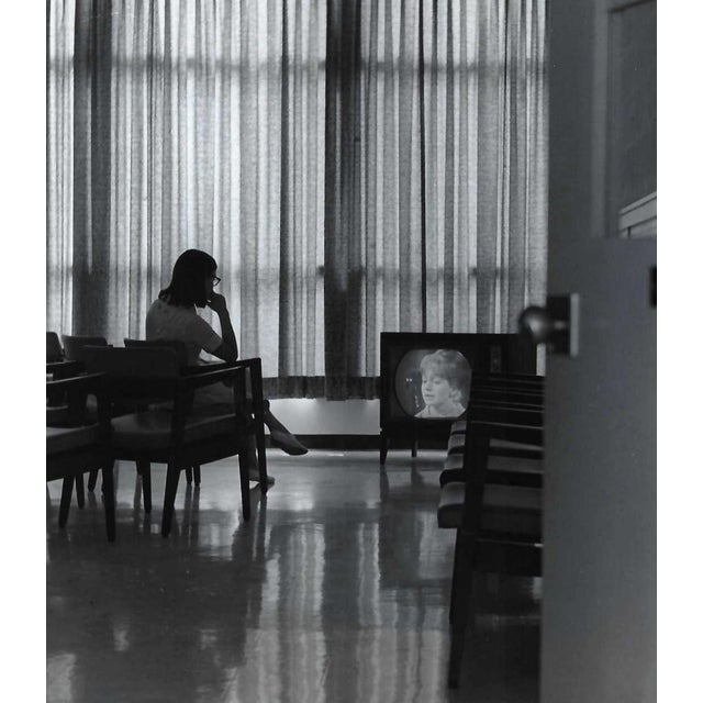 1960s black and white photograph of a lady watching tv in a room at an institution, probably a hospital or dorm. Unsigned...