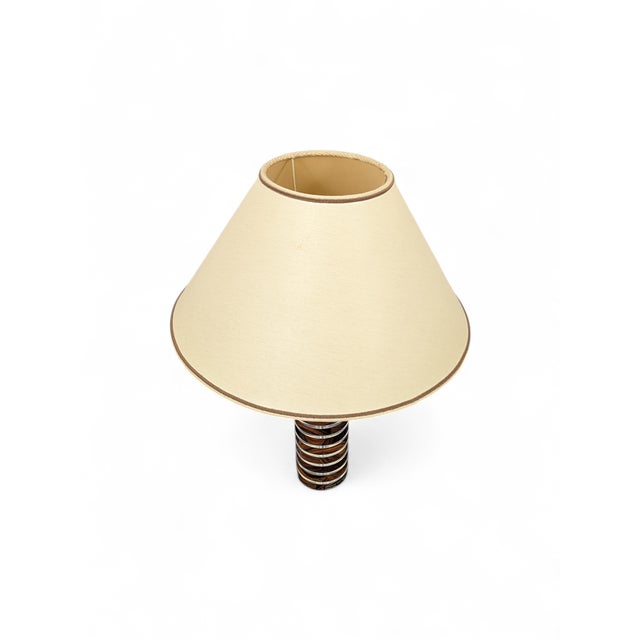 This iconic table lamp, designed by feliceantonio botta (florence, 1973), combines high-quality materials that were...