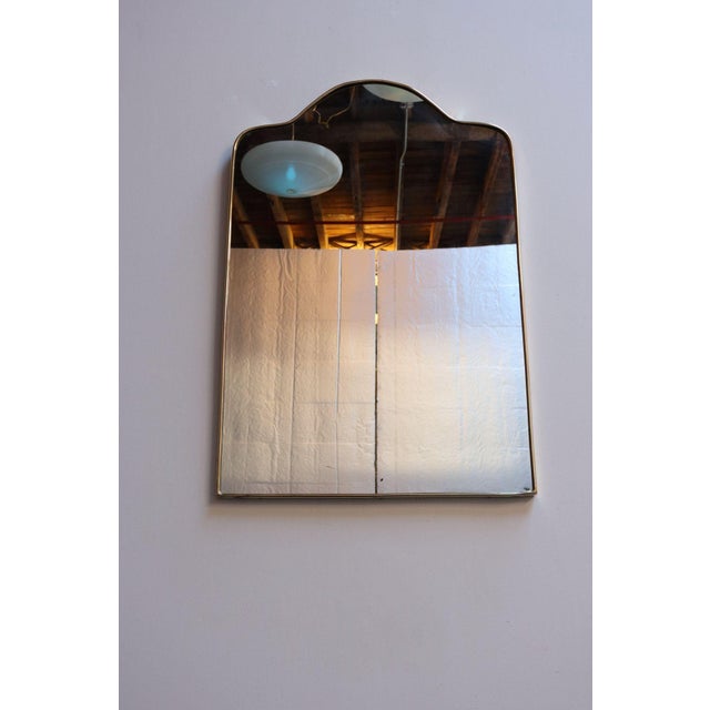 Gio Ponti-style brass rectangular wall mirror with curved edges and an arched/domed top (ca. 1950s, Italy). Overall, in...