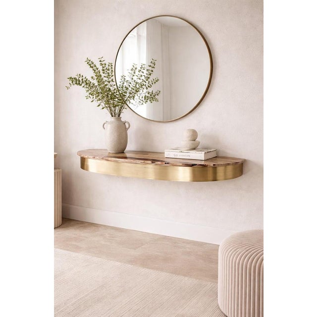 Italian console table from the 1950s with an elongated natural onyx top framed by a curved brass surround. The onyx...
