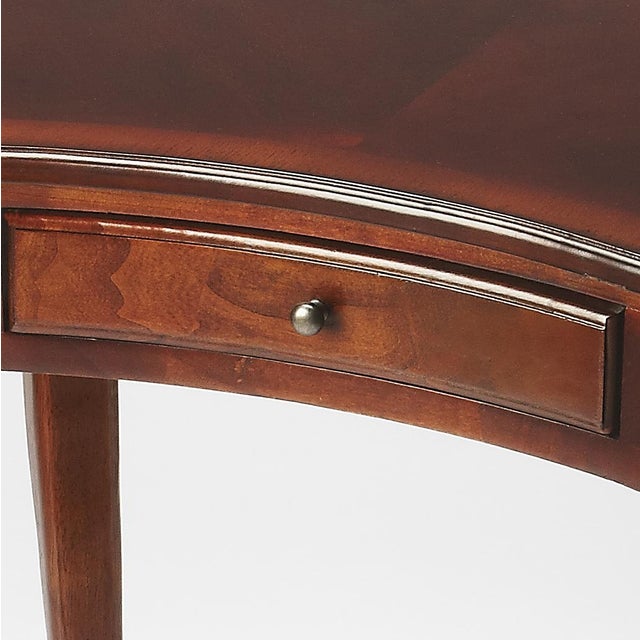 This elegant Writing Desk features a crescent shape tabletop supported by four stylized, tapered cabriole legs and a...
