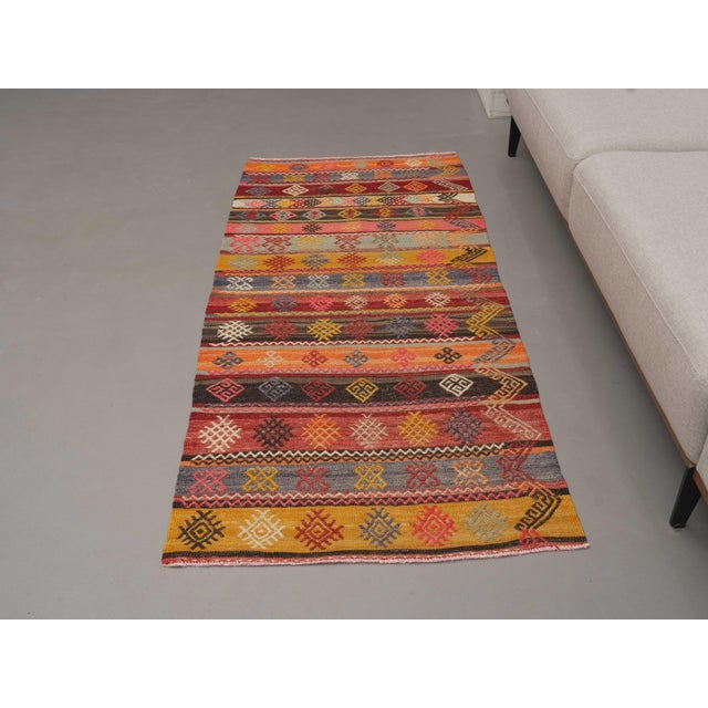Vintage Hand-Knotted runner rug is a semi-antique vintage runner rug. The '70s Eastern region of Anatolia's unique rug is...